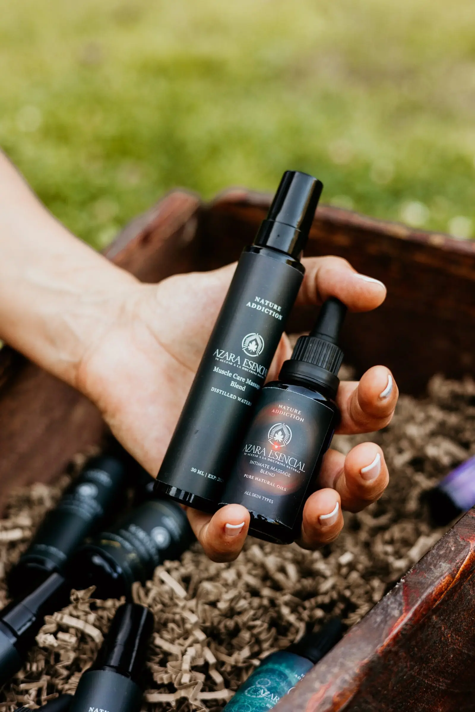 Intimate massage blend BY azara natural cinematic product shot in the nature while the product is in the hands of a girl