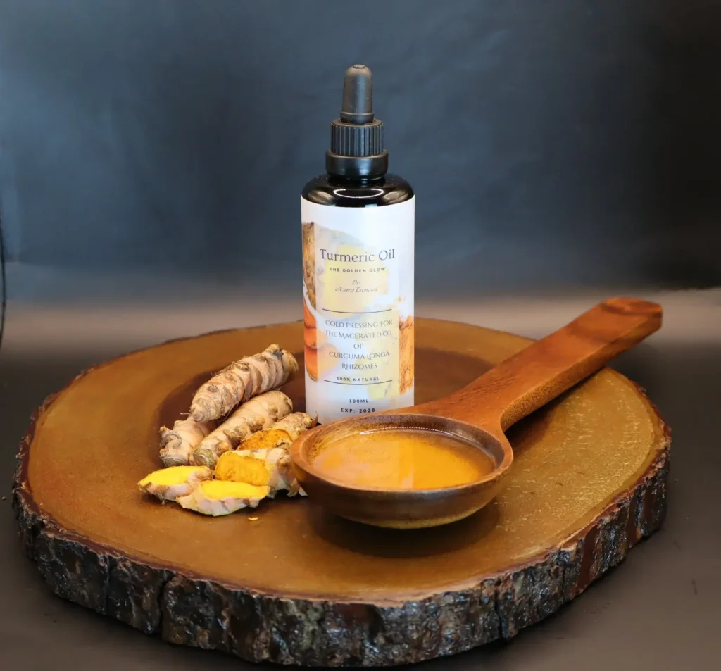 Turmeric oil bottle BY azara natural professional product shot with black background and wooden spoon full of the oil and Turmeric tubers all of them of wooden circular base