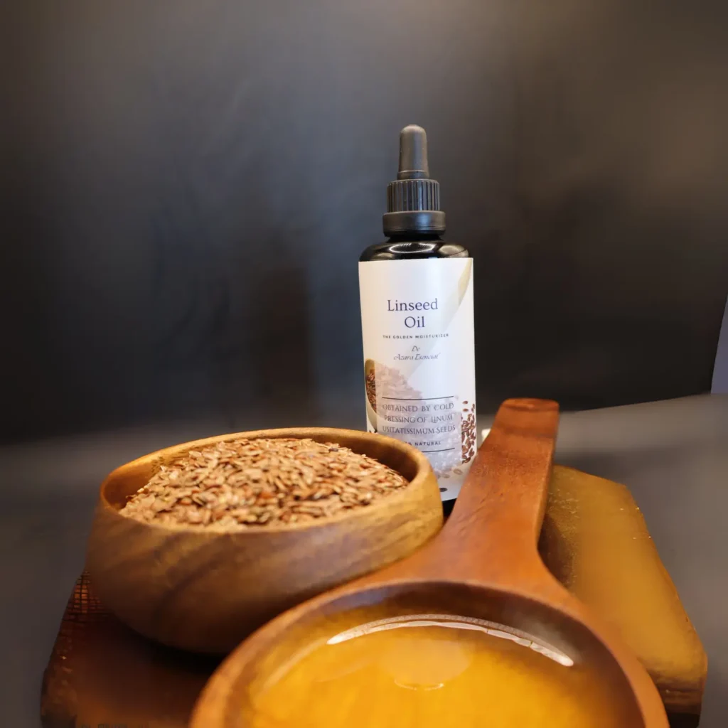 linseed oil By azara natural with wooden spoon of the oil and another full of linseeds with black background and circular wooden stand