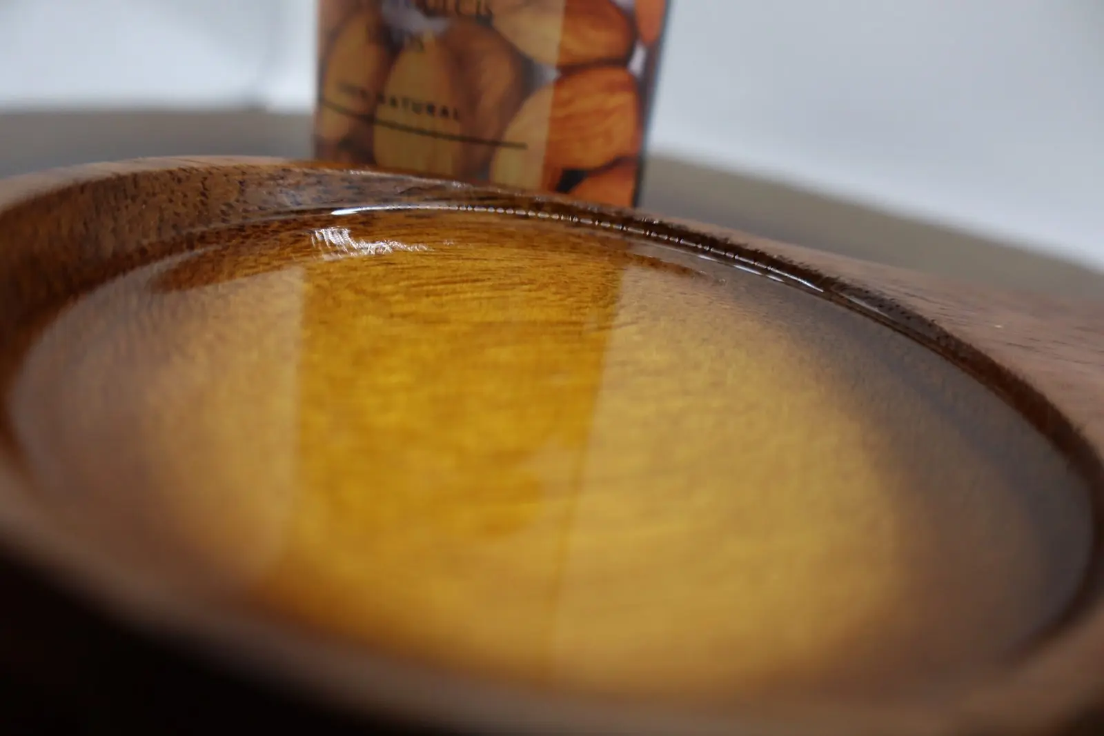 wooden-cup-of-cold-pressed-almond-oil-BY- azara natural